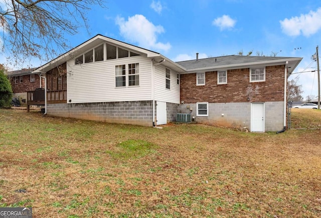 back of property featuring a yard, central AC, and a sunroom