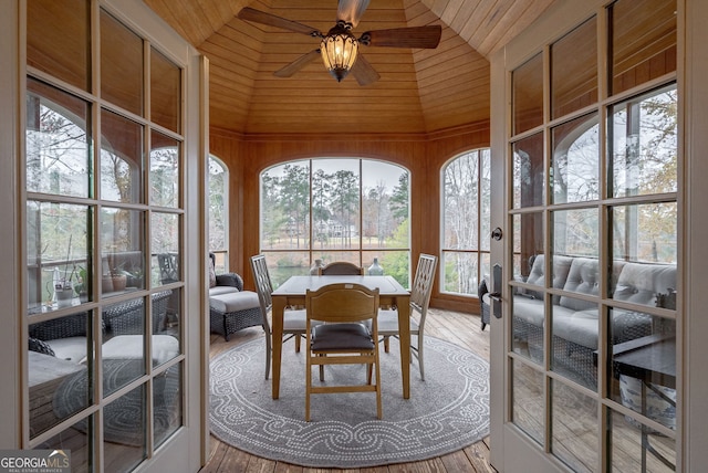 sunroom with ceiling fan, wooden ceiling, and vaulted ceiling