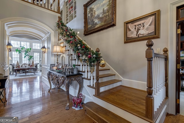 staircase with hardwood / wood-style floors