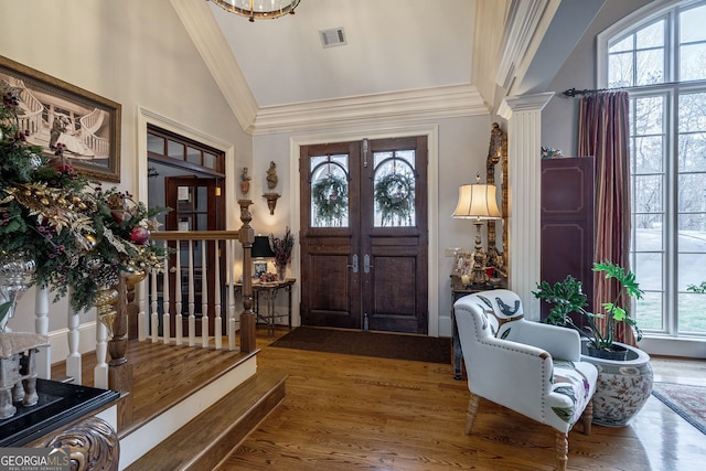 foyer featuring hardwood / wood-style floors, french doors, vaulted ceiling, and a wealth of natural light