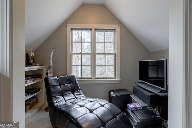 living area with light colored carpet and vaulted ceiling