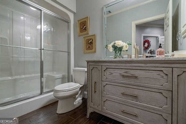 bathroom with vanity, an enclosed shower, and toilet