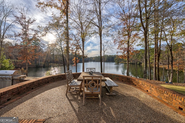 view of patio / terrace featuring grilling area and a water view