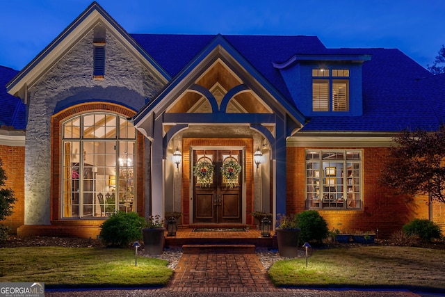 exterior entry at dusk featuring french doors