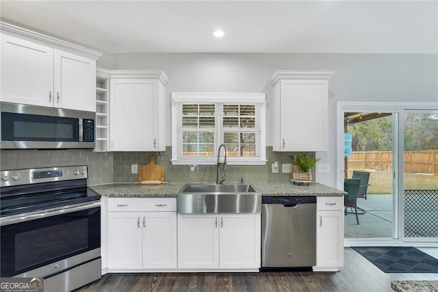 kitchen featuring dark hardwood / wood-style flooring, white cabinetry, sink, and appliances with stainless steel finishes