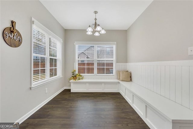 unfurnished room featuring a chandelier and dark hardwood / wood-style floors