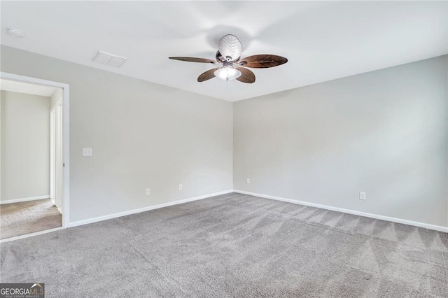 spare room with carpet and ceiling fan