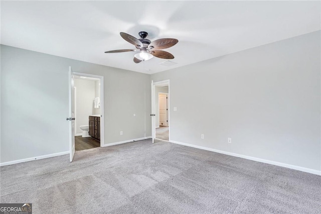 unfurnished bedroom featuring ceiling fan, carpet floors, and ensuite bathroom