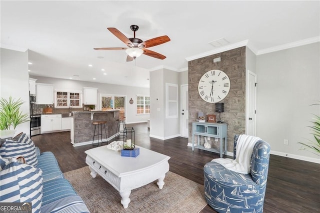 living room with dark hardwood / wood-style floors, ceiling fan, ornamental molding, and sink