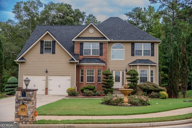 view of front of property with a front yard and a garage