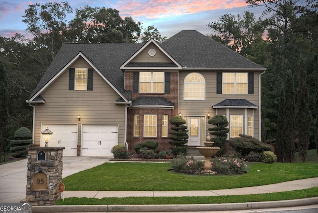 view of front of home with a garage and a lawn