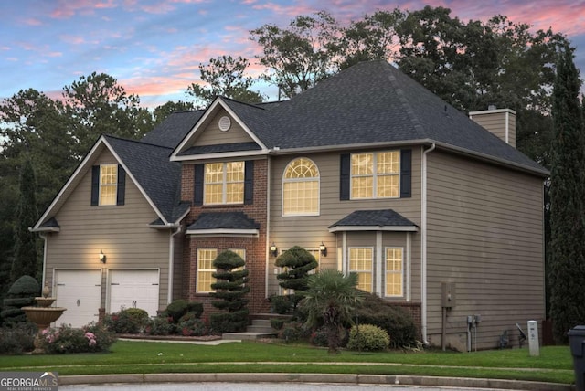 view of front of house with a yard and a garage