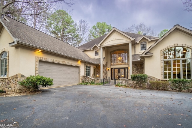 view of front property with french doors and a garage