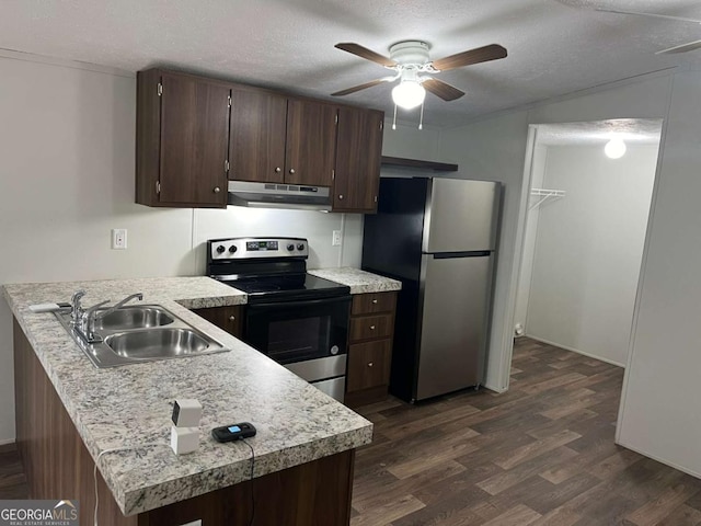 kitchen featuring a textured ceiling, kitchen peninsula, sink, and appliances with stainless steel finishes