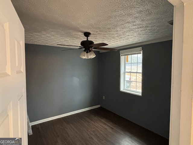 spare room featuring a textured ceiling, dark hardwood / wood-style flooring, and ceiling fan