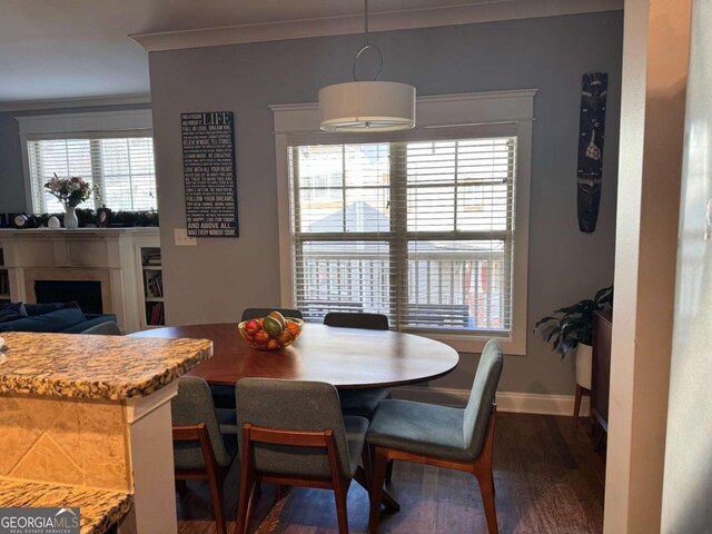 dining space featuring dark hardwood / wood-style flooring and ornamental molding