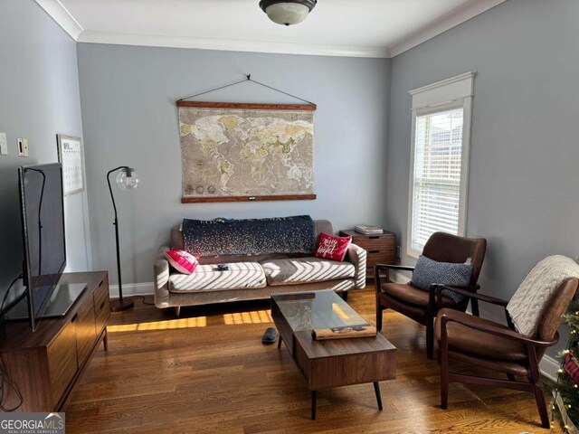 sitting room featuring wood-type flooring and crown molding