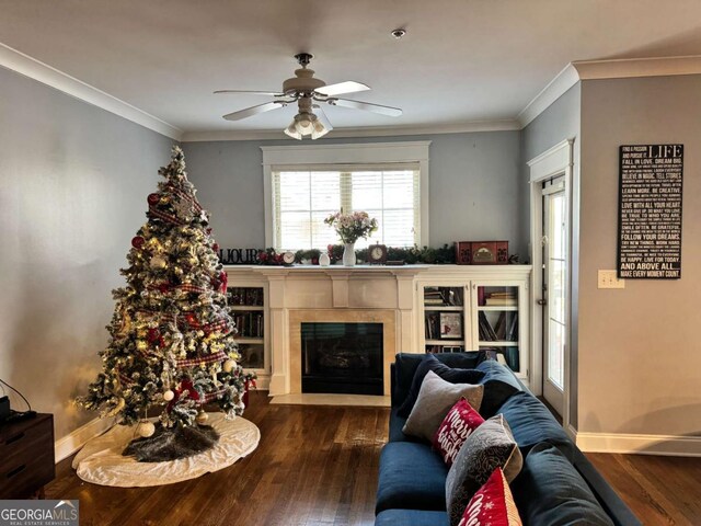 living room featuring dark hardwood / wood-style floors, ceiling fan, and ornamental molding