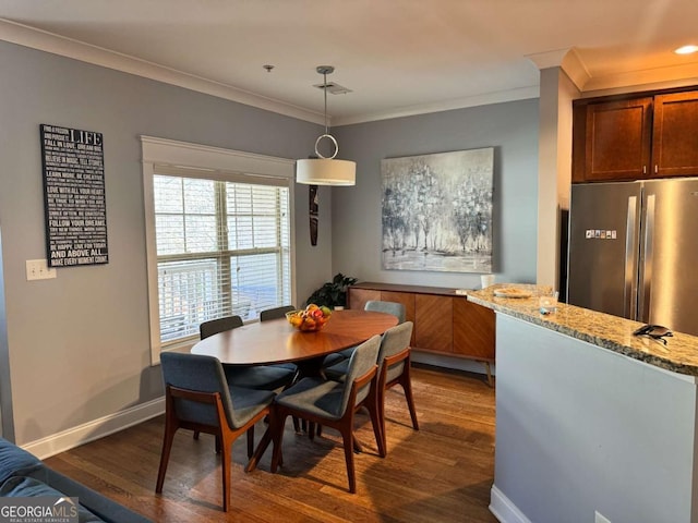 dining space with crown molding and dark hardwood / wood-style floors