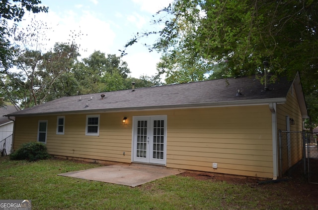 rear view of house featuring a patio area, a yard, and french doors