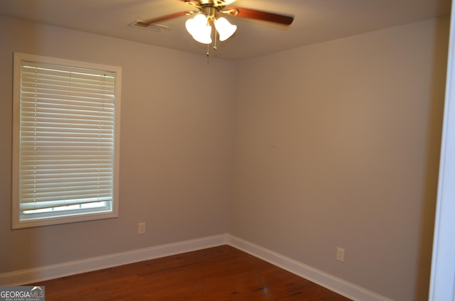 unfurnished room featuring dark hardwood / wood-style flooring and ceiling fan