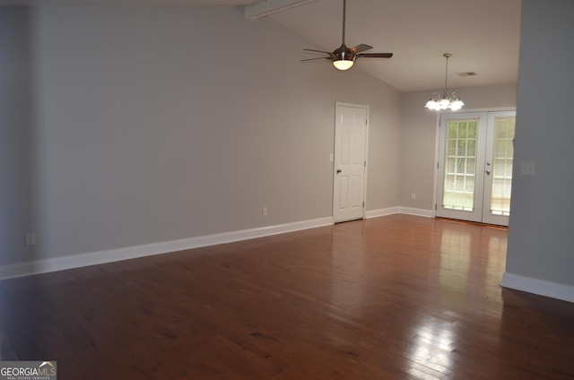 empty room featuring dark hardwood / wood-style floors, lofted ceiling with beams, ceiling fan with notable chandelier, and french doors