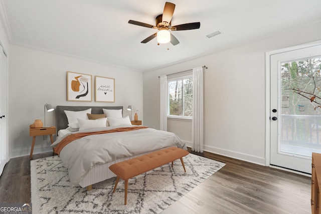 bedroom featuring dark hardwood / wood-style floors, ceiling fan, ornamental molding, and access to exterior