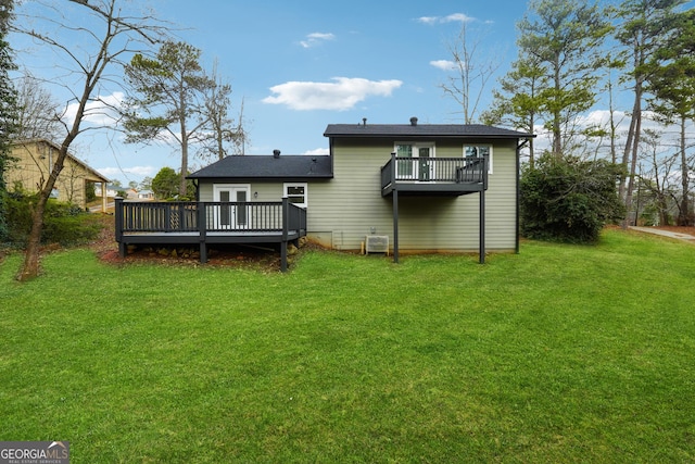 back of house featuring a wooden deck and a yard