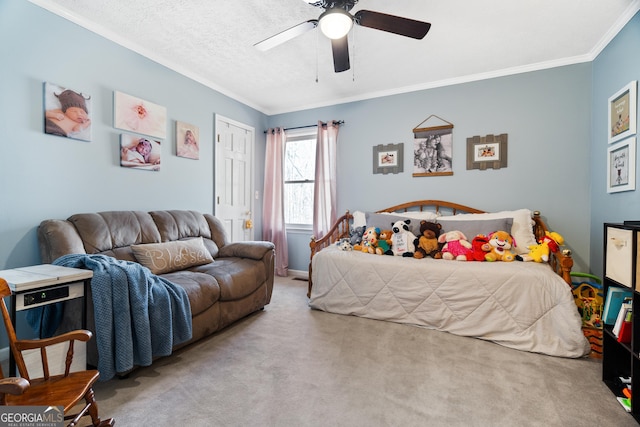 carpeted bedroom with a textured ceiling, ceiling fan, and crown molding