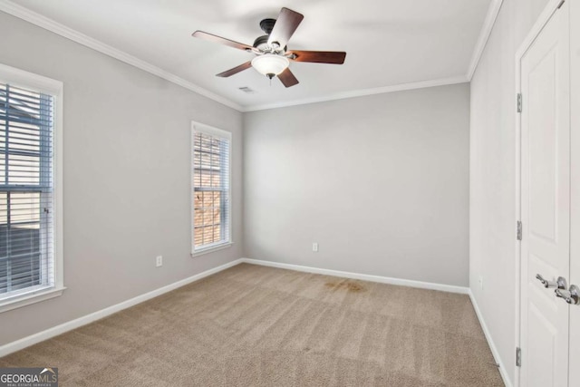 unfurnished bedroom featuring ceiling fan, light colored carpet, crown molding, and multiple windows