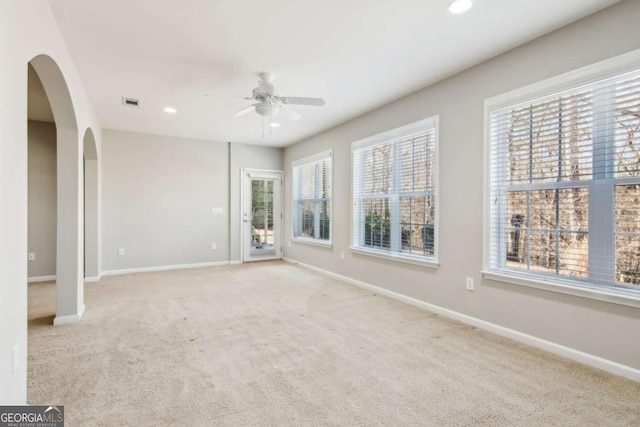 empty room with ceiling fan and light colored carpet