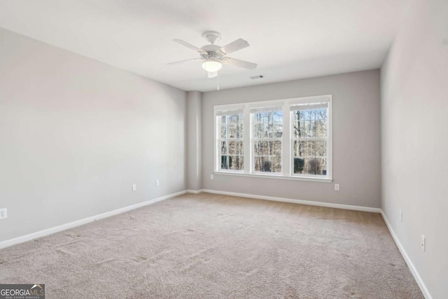 empty room with carpet flooring and ceiling fan