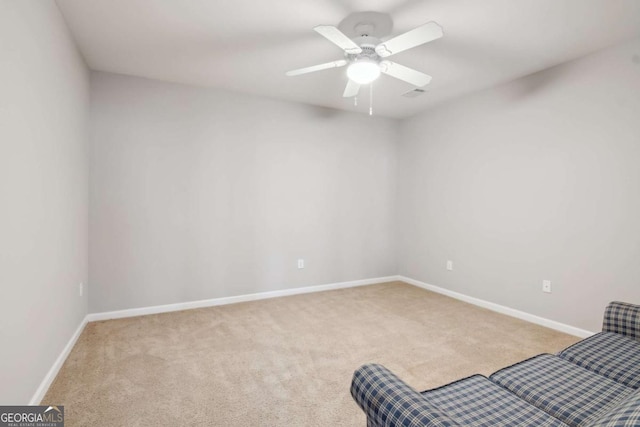 unfurnished room with ceiling fan and light carpet