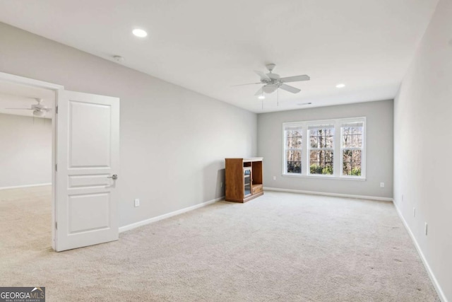 interior space with ceiling fan and light carpet