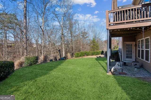 view of yard featuring a patio area and a deck