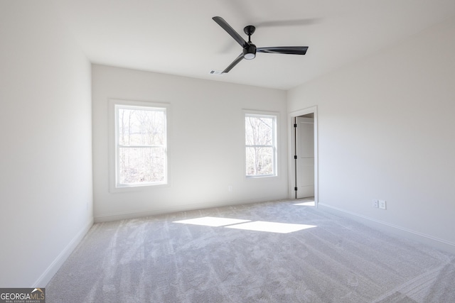 unfurnished room featuring light carpet and ceiling fan