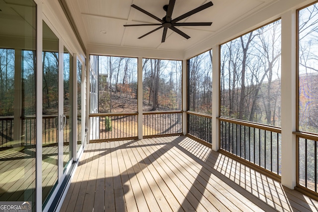 unfurnished sunroom featuring ceiling fan