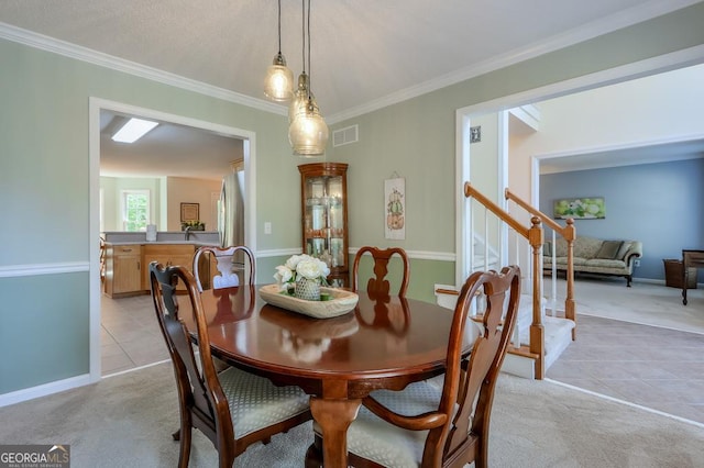 carpeted dining room with crown molding