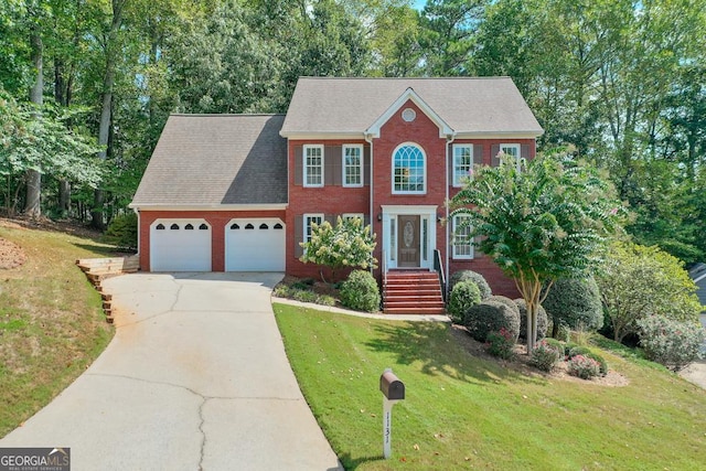 colonial home with a garage and a front lawn