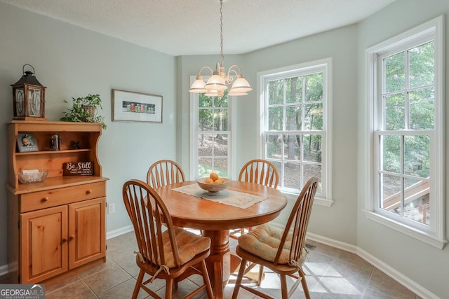 tiled dining room with a chandelier