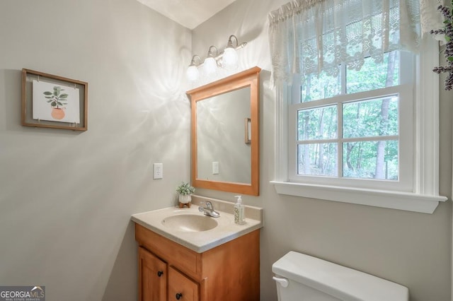 bathroom featuring toilet and vanity