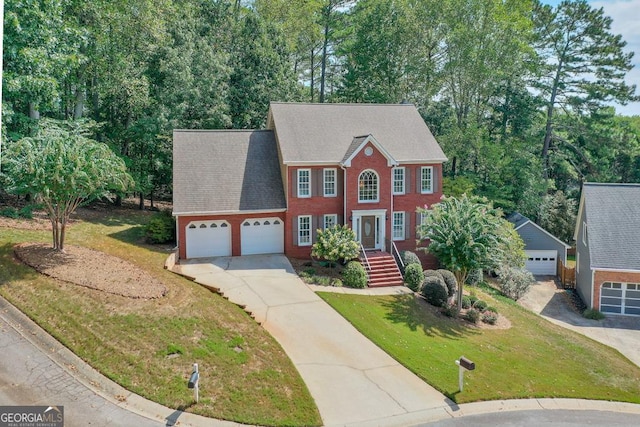 colonial home featuring a front lawn and a garage