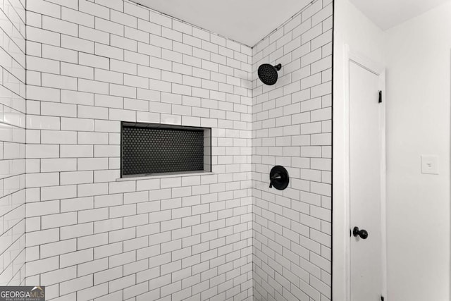 bathroom with a tile shower