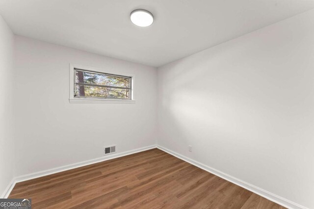 empty room with dark hardwood / wood-style floors