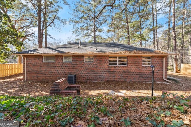 rear view of house featuring central AC unit