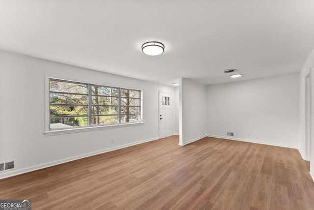 empty room with light hardwood / wood-style floors