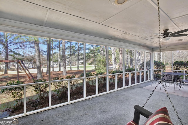 unfurnished sunroom with ceiling fan and a healthy amount of sunlight