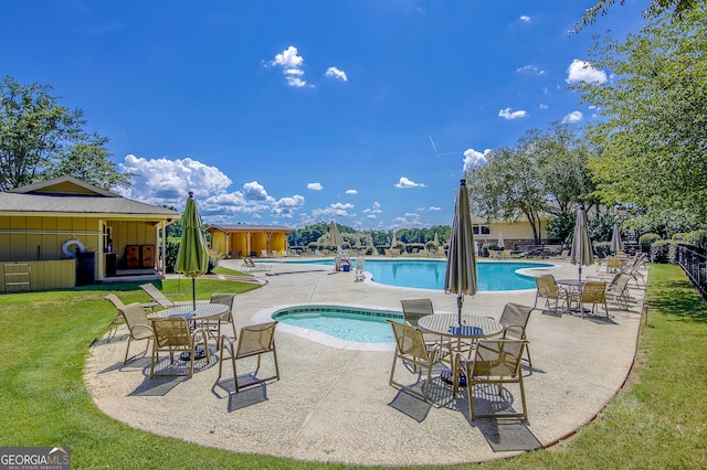 view of swimming pool with a yard and a patio area