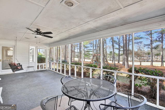 sunroom / solarium featuring ceiling fan and a wealth of natural light