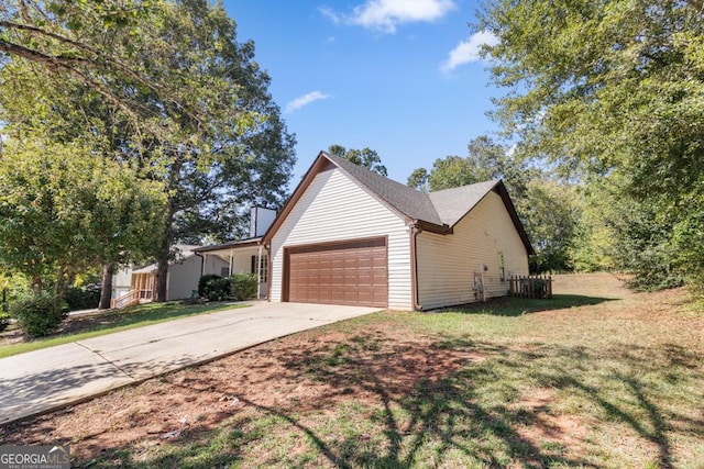 view of front of property with a garage and a front lawn